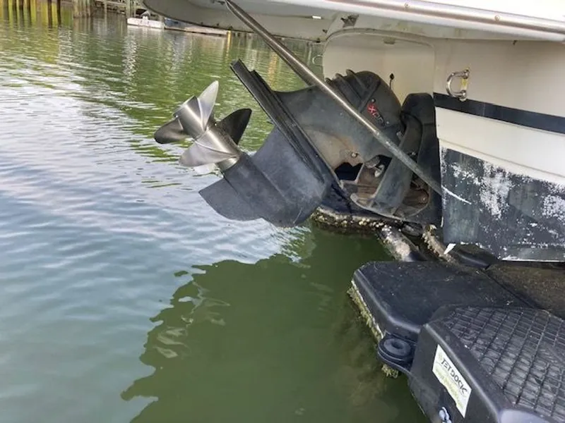 Slide: The Image of Rear view of 2009 Regal 2450 Cuddy boat with propeller in water. - 36