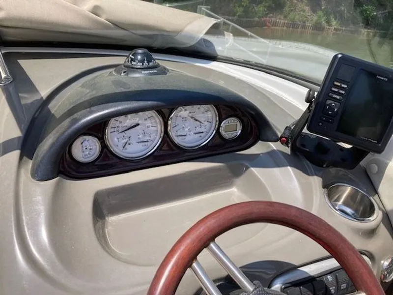 Slide: The Image of Dashboard of a 2009 Regal 2450 Cuddy boat with instruments. - 9
