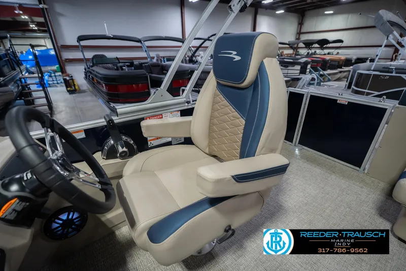 Slide: The Image of 2026 Bennington 21 SLJ boat interior with luxury captain's chair and steering wheel. - 22
