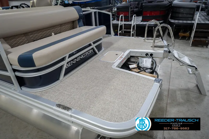 Slide: The Image of 2026 Bennington 21 SLJ pontoon boat with beige seating and rear deck ladder. - 49