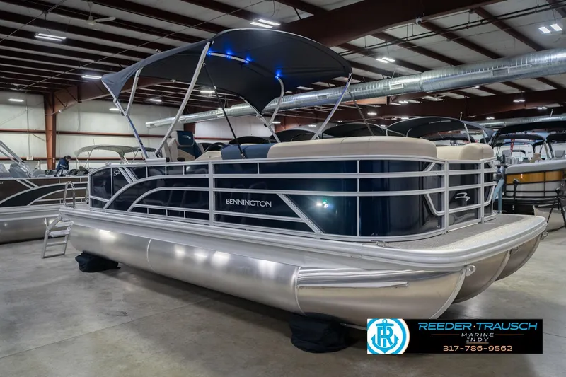 Slide: The Image of 2026 Bennington 21 SLJ pontoon boat in indoor showroom with canopy. - 6