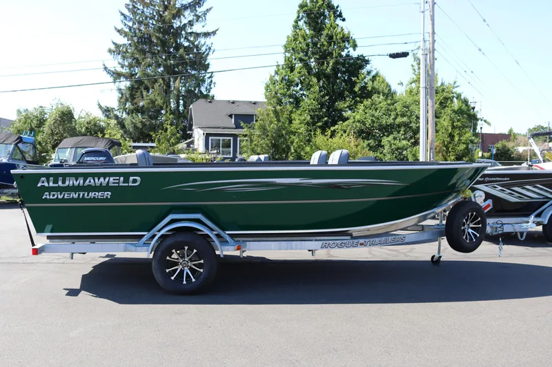 The Image of 2026 Alumaweld Adventurer 20 boat on trailer, green exterior, parked outdoors. - 0
