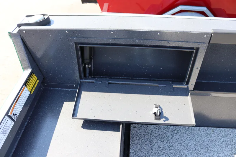 Slide: The Image of 2026 Alumaweld Adventurer 20 boat storage compartment with open hatch and latch mechanism. - 13