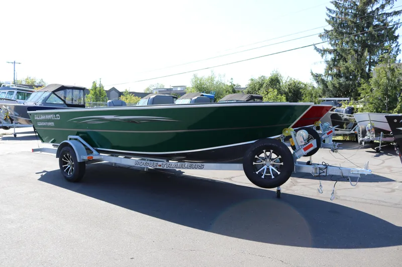 Slide: The Image of 2026 Alumaweld Adventurer 20 boat on trailer, parked outdoors in sunny setting. - 2