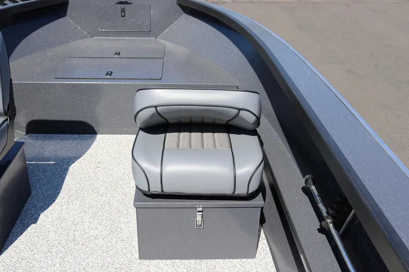 Slide: The Image of 2026 Alumaweld Adventurer 20 boat interior with gray cushioned seat and storage compartment. - 5