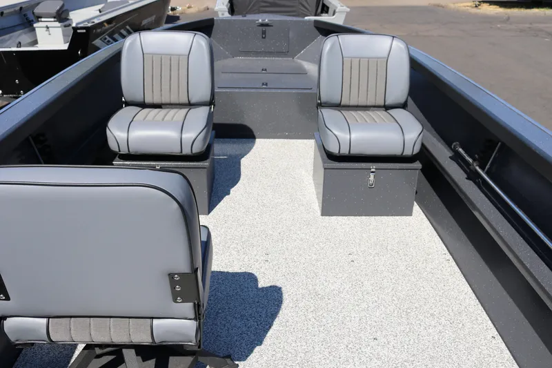 Slide: The Image of 2026 Alumaweld Adventurer 20 boat interior with gray seating and spacious layout. - 7