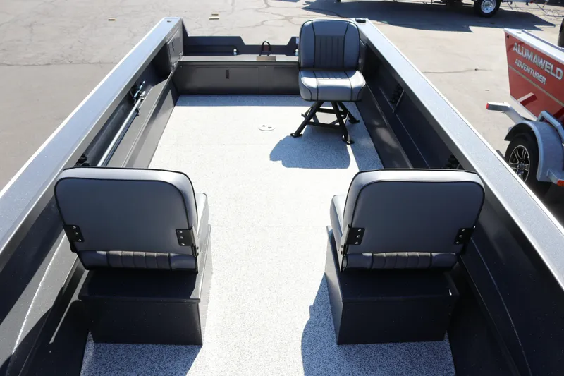 Slide: The Image of 2026 Alumaweld Adventurer 20 boat interior with three gray seats and spacious deck. - 8