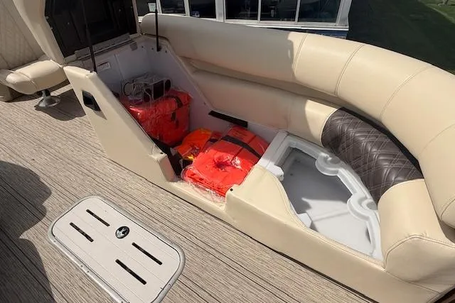 Slide: The Image of 2021 Premier 250 Grand Majestic RF boat interior with life jackets and storage compartments. - 13
