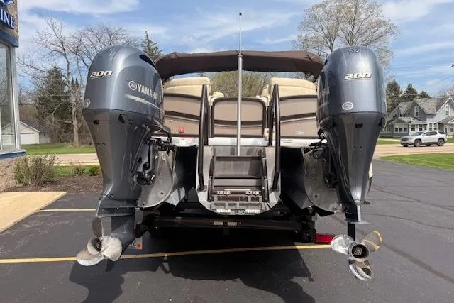 Slide: The Image of 2021 Premier 250 Grand Majestic RF boat with dual Yamaha 200 engines, parked outdoors. - 2