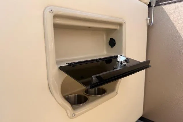 Slide: The Image of Built-in cup holders and storage on a 2021 Premier 250 Grand Majestic RF boat. - 20