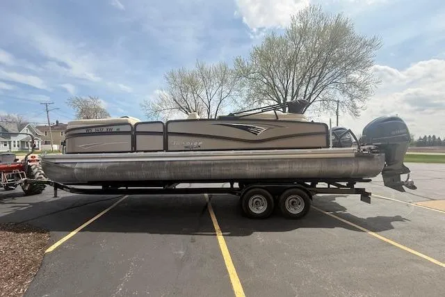 Slide: The Image of 2021 Premier 250 Grand Majestic RF pontoon boat on trailer in parking lot. - 4