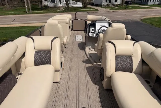 Slide: The Image of 2021 Premier 250 Grand Majestic RF pontoon boat with luxurious seating and modern dashboard. - 5