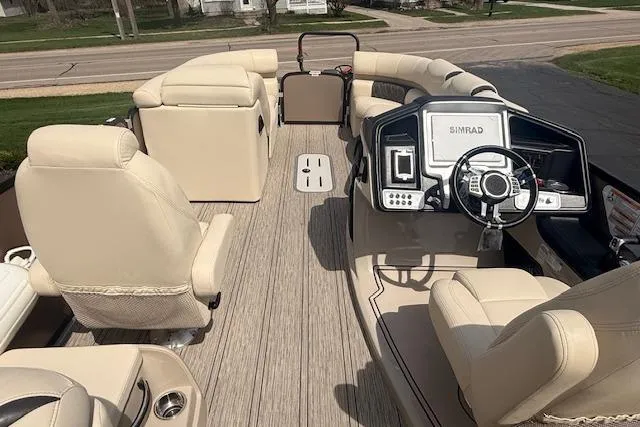 Slide: The Image of 2021 Premier 250 Grand Majestic RF pontoon boat interior with beige seating and modern dashboard. - 6