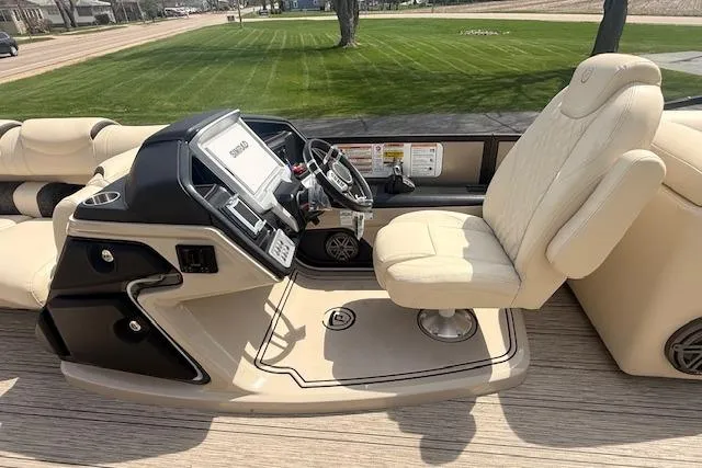 Slide: The Image of Luxurious 2021 Premier 250 Grand Majestic RF boat interior with beige captain's chair and control panel. - 7