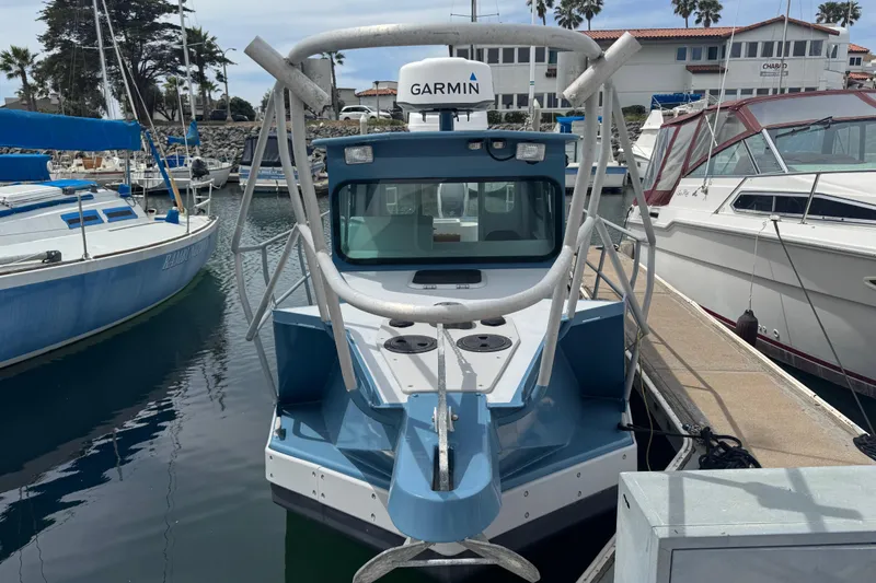 Slide: The Image of Blue ACB 30 boat docked at marina, featuring Garmin equipment, surrounded by other vessels. - 3