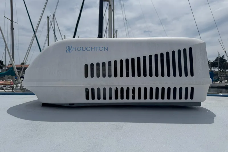 Slide: The Image of Rooftop air conditioning unit on a boat, labeled "Houghton," with marina background. - 6