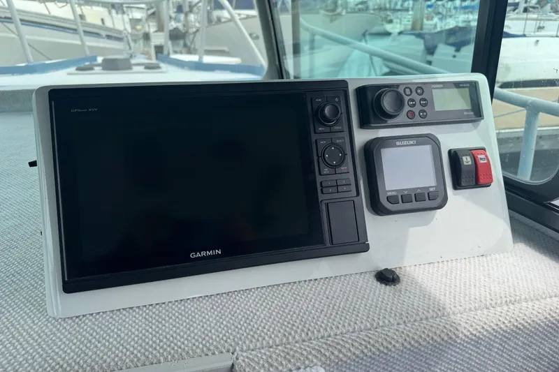 Slide: The Image of Boat dashboard with Garmin GPS, Suzuki display, and control panel, ACB 30, 2003 model. - 8