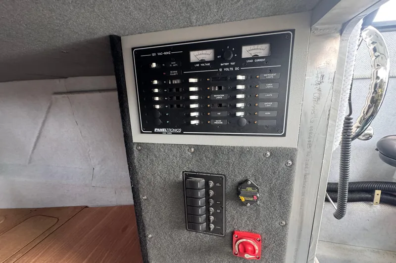 Slide: The Image of Electrical control panel in ACB 30, 2003 model, featuring switches and meters. - 9