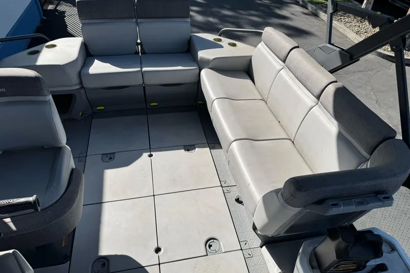 Slide: The Image of 2023 Sea-Doo Switch Cruise 21 interior seating with gray upholstery and spacious layout. - 10