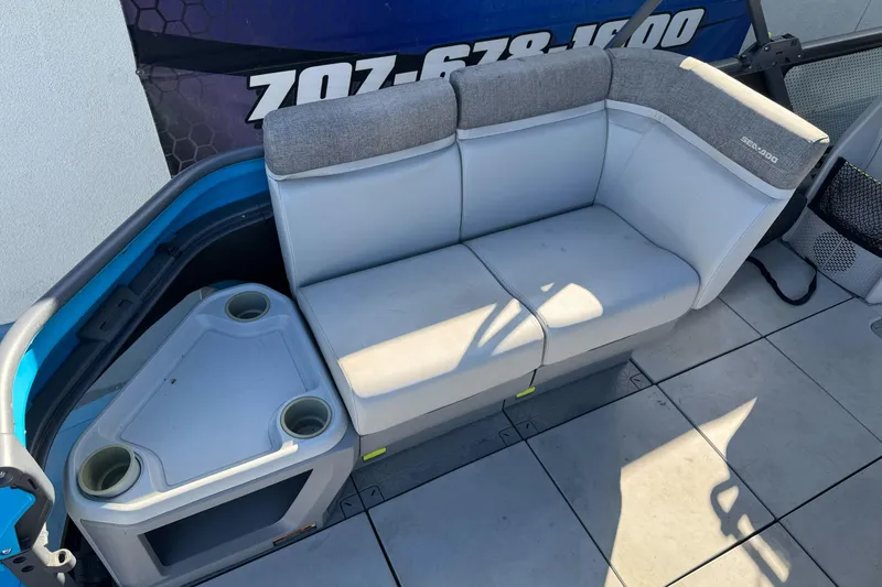 Slide: The Image of 2023 Sea-Doo Switch Cruise 21 boat seating area with cup holders and storage. - 11