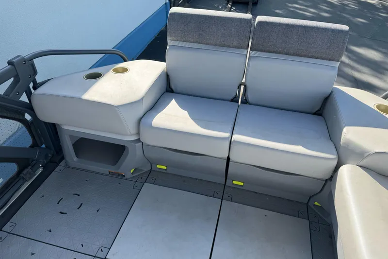 Slide: The Image of 2023 Sea-Doo Switch Cruise 21 interior seating with cup holders and storage. - 17