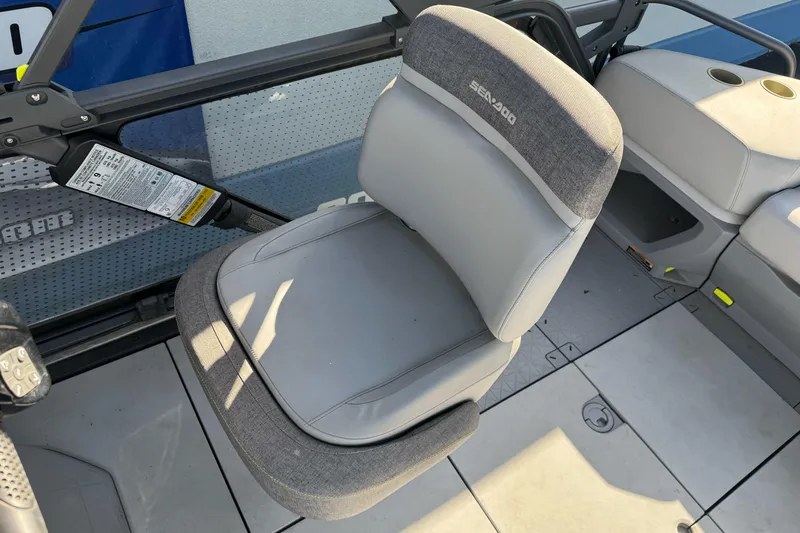Slide: The Image of 2023 Sea-Doo Switch Cruise 21 interior with gray seating and steering controls. - 21