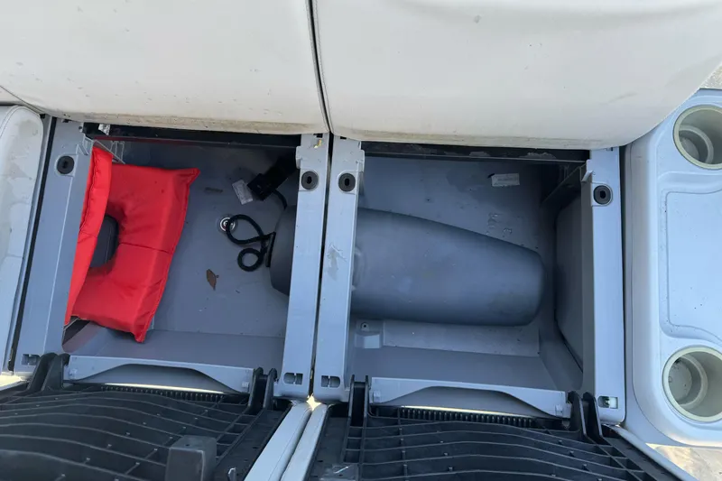 Slide: The Image of Storage compartment of 2023 Sea-Doo Switch Cruise 21 with red life jacket and accessories. - 24
