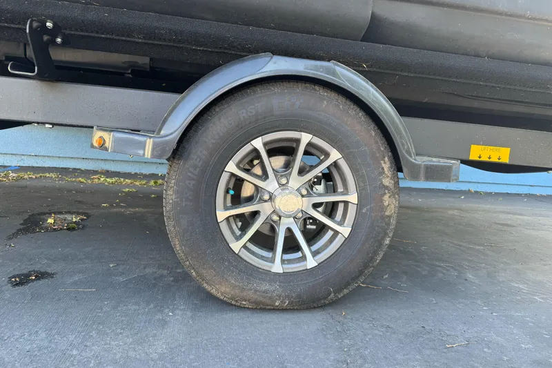 Slide: The Image of Trailer wheel of 2023 Sea-Doo Switch Cruise 21 on pavement. - 3