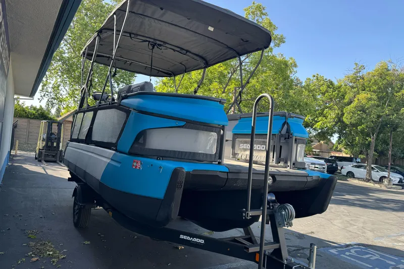 Slide: The Image of 2023 Sea-Doo Switch Cruise 21 pontoon boat on trailer, parked outdoors. - 7