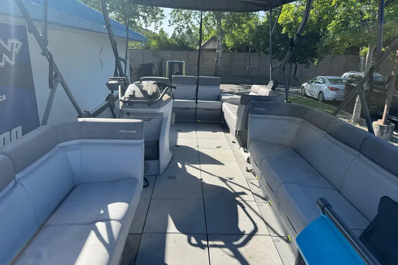 Slide: The Image of 2023 Sea-Doo Switch Cruise 21 pontoon boat interior with spacious seating and helm. - 9