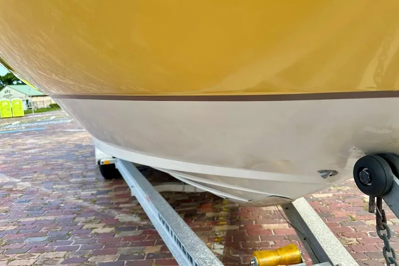 Slide: The Image of 2004 Sea Ray 270 Sundeck boat on trailer, close-up view of hull and trailer. - 10