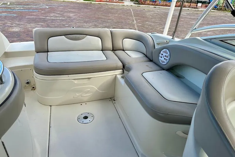 Slide: The Image of Interior seating of a 2004 Sea Ray 270 Sundeck boat, featuring cushioned benches. - 21