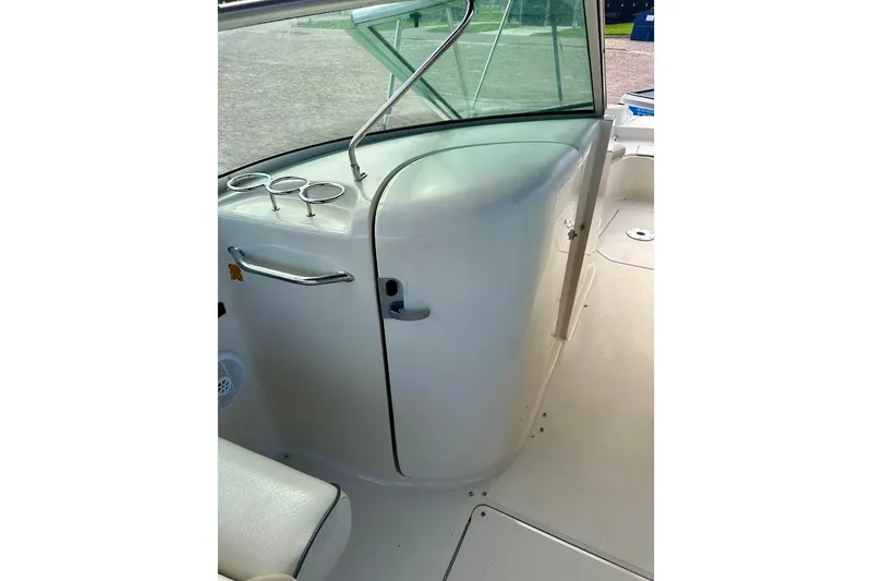 Slide: The Image of 2004 Sea Ray 270 Sundeck interior with cup holders and sleek design. - 27