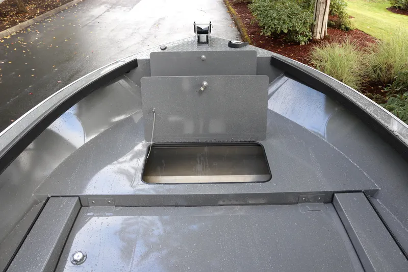 Slide: The Image of 2026 Alumaweld Free Drifter 18 boat interior with storage compartment, sleek gray design. - 6