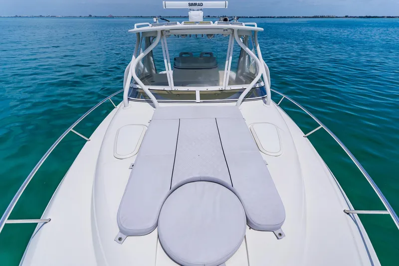 Slide: The Image of 2008 Hydra-Sports Vector 3500 VX boat on calm blue water, featuring a spacious deck. - 13