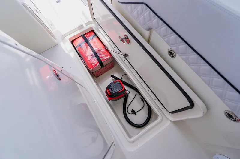 Slide: The Image of Storage compartment in a 2008 Hydra-Sports Vector 3500 VX boat with safety equipment. - 19