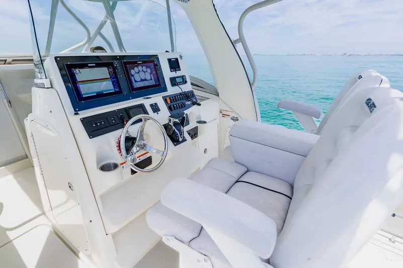 Slide: The Image of 2008 Hydra-Sports Vector 3500 VX helm with dual displays and plush seating on open water. - 25