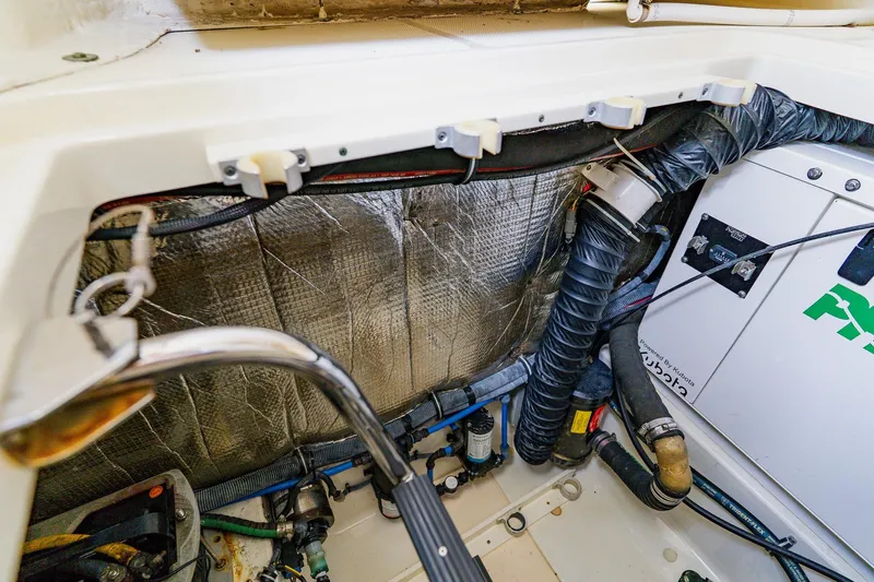 Slide: The Image of Engine compartment of a 2008 Hydra-Sports Vector 3500 VX boat, showing wiring and insulation. - 32