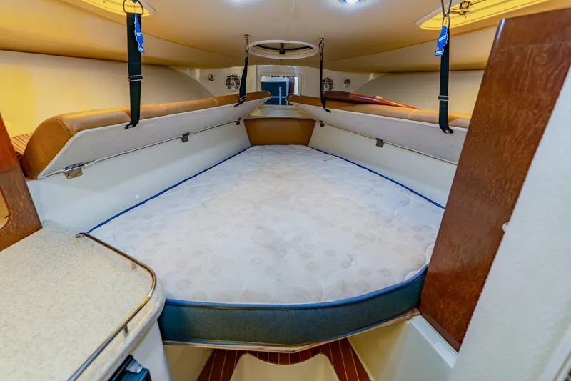 Slide: The Image of 2008 Hydra-Sports Vector 3500 VX cabin interior with spacious bed and wooden accents. - 50