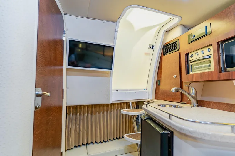 Slide: The Image of Interior of 2008 Hydra-Sports Vector 3500 VX boat with kitchenette and TV. - 53