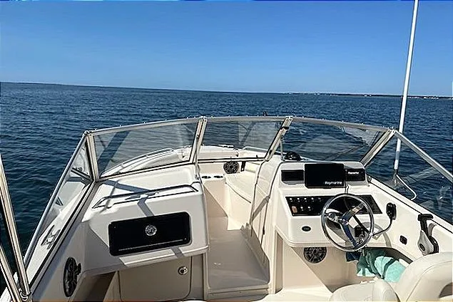 Slide: The Image of 2020 Grady-White Freedom 192 boat interior with steering wheel, dashboard, and ocean view. - 12