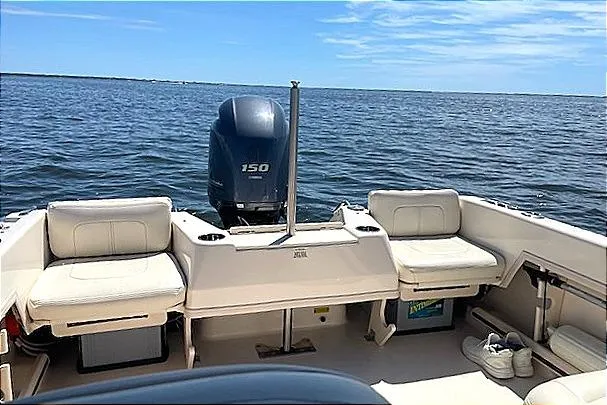 Slide: The Image of 2020 Grady-White Freedom 192 boat interior with seating, ocean view, and outboard motor. - 14