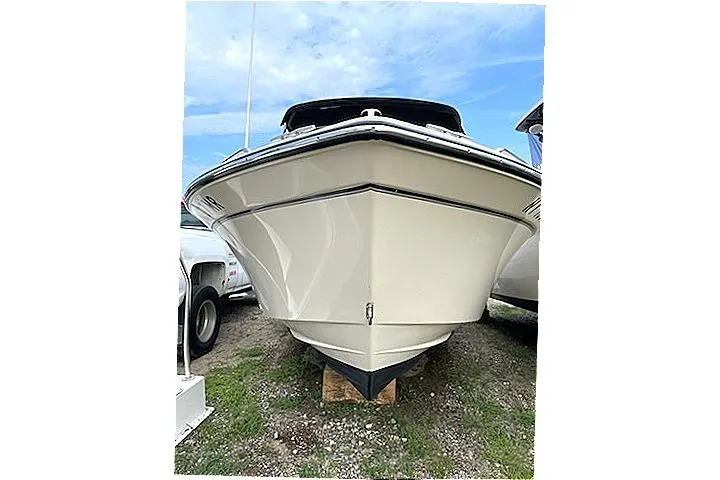 Slide: The Image of 2020 Grady-White Freedom 192 boat, front view, parked on grass under a blue sky. - 15