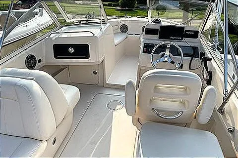 Slide: The Image of 2020 Grady-White Freedom 192 boat interior with white seating and modern dashboard. - 2