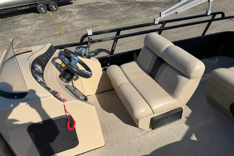 Slide: The Image of 2012 Bentley Pontoons 240 CRUISE interior with beige seating and steering console. - 3