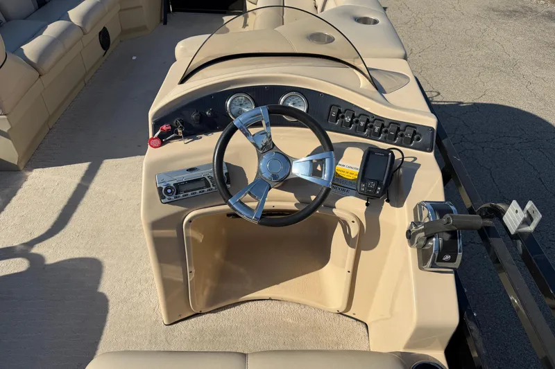 Slide: The Image of 2012 Bentley Pontoons 240 CRUISE dashboard with steering wheel and control panel. - 4