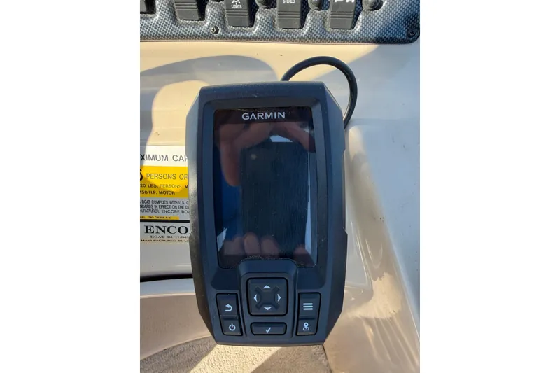 Slide: The Image of Garmin device on 2012 Bentley Pontoons 240 CRUISE dashboard, with control buttons visible. - 6