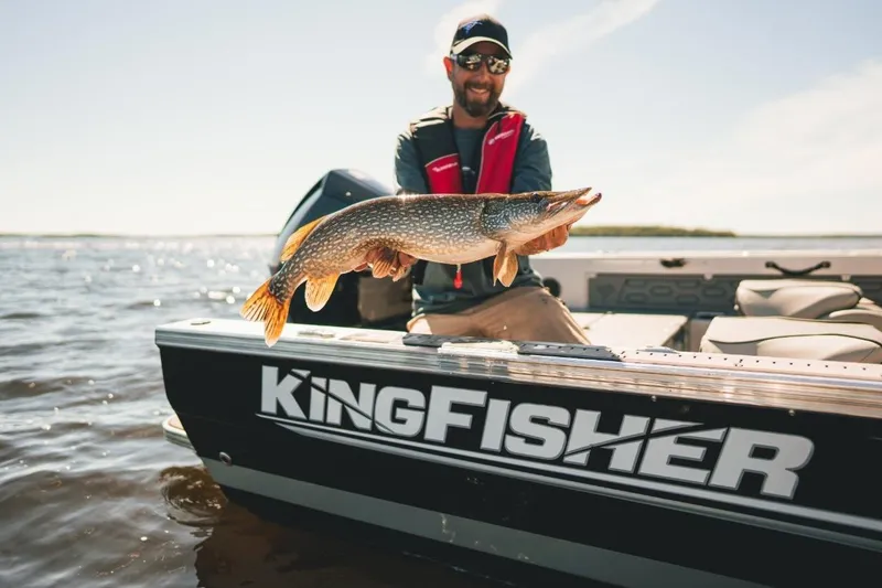 Slide: The Image of Man holding fish on KingFisher 2125 Arrow Sport boat, 2026 model, on a sunny day. - 16
