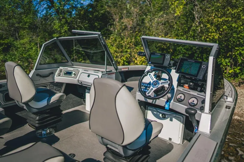 Slide: The Image of Interior of 2026 KingFisher 2125 Arrow Sport boat with modern dashboard and seating. - 4