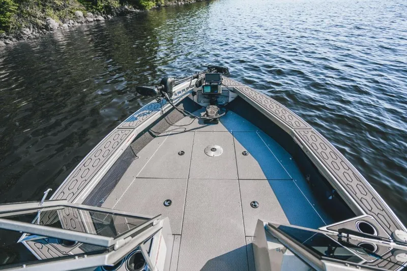 Slide: The Image of 2026 KingFisher 2125 Arrow Sport boat on calm water, featuring a spacious deck and modern controls. - 7